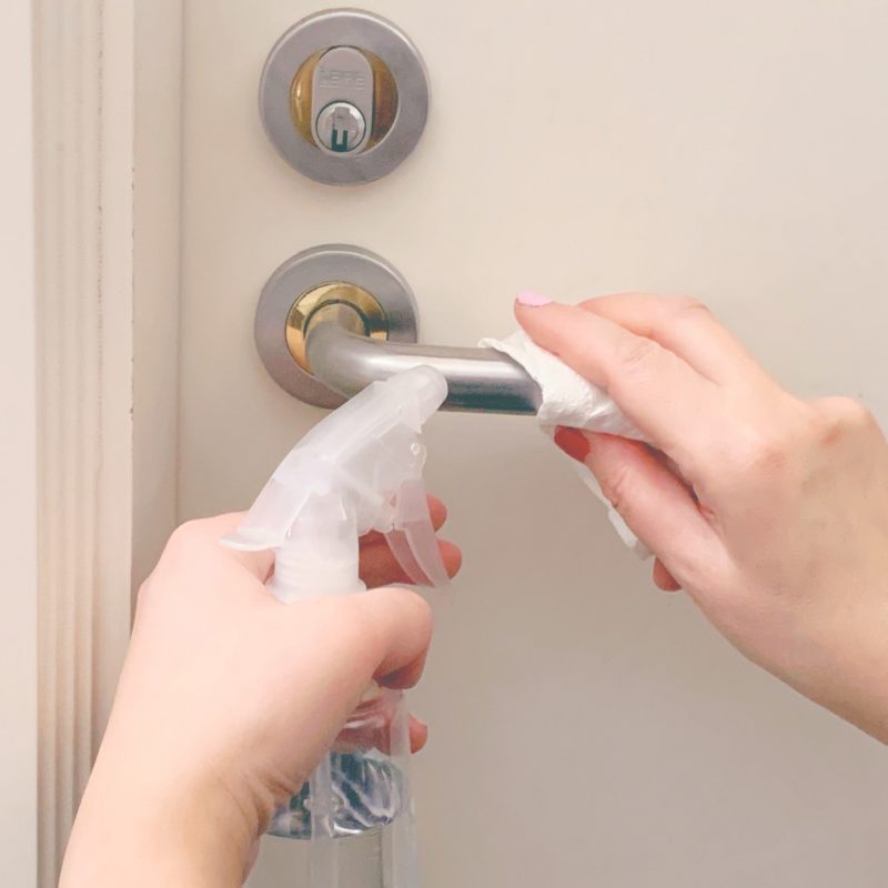 woman-s-hands-sanitizing-and-cleaning-a-frequently-touched-and-used-door-handle-to-remove-germs-and_t20_N0lLg7.jpg